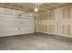 Two car garage with unfinished walls and a white door at 9136 Cocowoods Pl, Las Vegas, NV 89148