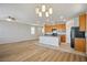 Bright kitchen with a center island, wood cabinets, and a seamless transition into the living area at 9136 Cocowoods Pl, Las Vegas, NV 89148