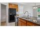 The kitchen has stainless steel appliances, light cabinets, a sink, and granite countertops at 9136 Cocowoods Pl, Las Vegas, NV 89148