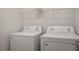 Laundry room featuring a washer, dryer, and shelving at 9136 Cocowoods Pl, Las Vegas, NV 89148