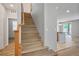 Bright open staircase leading to the upper level with views of the adjacent living spaces at 9136 Cocowoods Pl, Las Vegas, NV 89148