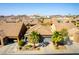 An aerial view of a home with mature landscaping, a two-car garage, and barrel tile roof at 1004 Viale Placenza Pl, Henderson, NV 89011