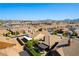 Scenic aerial view of a residential community nestled against a mountain backdrop under a clear blue sky at 1004 Viale Placenza Pl, Henderson, NV 89011