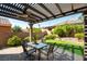 Relaxing covered patio area with ceiling fan and well-manicured landscaping at 1004 Viale Placenza Pl, Henderson, NV 89011