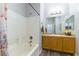 Bathroom with tub/shower combo and vanity with neutral countertops and flooring at 1004 Viale Placenza Pl, Henderson, NV 89011