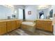 This primary bathroom boasts double sinks, a soaking tub, and tiled floors at 1004 Viale Placenza Pl, Henderson, NV 89011