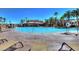 Large, inviting community pool area featuring comfortable lounge chairs and clear blue skies at 1004 Viale Placenza Pl, Henderson, NV 89011