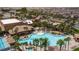 Aerial shot of a luxurious community pool area with palm trees and ample lounge space in a desert setting at 1004 Viale Placenza Pl, Henderson, NV 89011