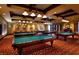 Attractive game room with multiple billiard tables, comfortable seating, and warm lighting at 1004 Viale Placenza Pl, Henderson, NV 89011