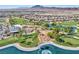 Scenic aerial view of a golf course with water features, palm trees, and surrounding residential area at 1004 Viale Placenza Pl, Henderson, NV 89011