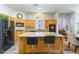 Cozy kitchen with an island, wooden cabinets, and modern appliances, perfect for cooking and entertaining at 1004 Viale Placenza Pl, Henderson, NV 89011