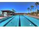 Community lap pool with clear blue water, lane markers, and a covered pavilion in the background at 1004 Viale Placenza Pl, Henderson, NV 89011