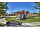 Community playground featuring a colorful play structure, climbing wall and slides at 1004 Viale Placenza Pl, Henderson, NV 89011