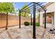 Charming outdoor patio with a stylish pergola, beautiful pavers and rock landscaping at 10557 Bandera Mountain Ln, Las Vegas, NV 89166