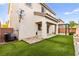 The backyard includes low-maintenance artificial grass and a covered patio at 10557 Bandera Mountain Ln, Las Vegas, NV 89166