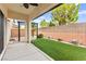 The backyard has a covered patio and well-maintained artificial grass at 10557 Bandera Mountain Ln, Las Vegas, NV 89166