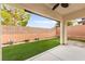 A covered patio and artificial grass make this backyard low maintenance at 10557 Bandera Mountain Ln, Las Vegas, NV 89166