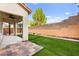 The backyard features artificial grass and a covered patio at 10557 Bandera Mountain Ln, Las Vegas, NV 89166