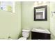 Stylish half-bathroom featuring a granite countertop vanity and framed mirror at 10557 Bandera Mountain Ln, Las Vegas, NV 89166