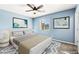 Staged bedroom featuring neutral walls, carpet flooring, window and ceiling fan at 10557 Bandera Mountain Ln, Las Vegas, NV 89166