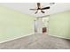 Bedroom with ceiling fan, neutral carpet, and access to an ensuite bathroom at 10557 Bandera Mountain Ln, Las Vegas, NV 89166