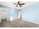 Bedroom with ceiling fan, neutral walls, carpet flooring and a closet at 10557 Bandera Mountain Ln, Las Vegas, NV 89166