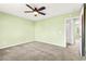 Bedroom featuring plush carpet, ceiling fan, and an ensuite bathroom entrance at 10557 Bandera Mountain Ln, Las Vegas, NV 89166
