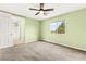 Bright bedroom with a ceiling fan, carpet, and an attached bathroom at 10557 Bandera Mountain Ln, Las Vegas, NV 89166