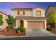 Charming two-story home features a tile roof and a well-maintained front yard at 10557 Bandera Mountain Ln, Las Vegas, NV 89166