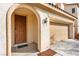 Welcoming front entrance with an arched entryway and a two car garage at 10557 Bandera Mountain Ln, Las Vegas, NV 89166