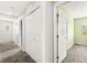 Hallway with carpet flooring and multiple doors that lead to different rooms in the home at 10557 Bandera Mountain Ln, Las Vegas, NV 89166