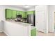 Kitchen with stainless steel appliances, mosaic backsplash, and green cabinets at 10557 Bandera Mountain Ln, Las Vegas, NV 89166