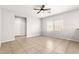 Bright living room with tile floors and natural light from two windows at 10557 Bandera Mountain Ln, Las Vegas, NV 89166