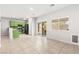Bright open-plan living area with modern green kitchen and access to outdoor patio at 10557 Bandera Mountain Ln, Las Vegas, NV 89166