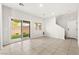 Bright living room with tile flooring, sliding glass doors to patio, and modern design at 10557 Bandera Mountain Ln, Las Vegas, NV 89166