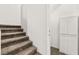 Carpeted staircase leading to upper level with white walls and a storage closet at 10557 Bandera Mountain Ln, Las Vegas, NV 89166