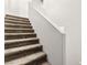 Carpeted stairs in a well-lit area with white walls offering a clean aesthetic at 10557 Bandera Mountain Ln, Las Vegas, NV 89166