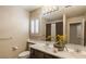 Bathroom featuring a double sink vanity, a large mirror, and a window with white blinds at 11241 Pentland Downs St, Las Vegas, NV 89141