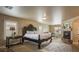 Spacious bedroom featuring a king bed, fireplace, sitting area, a decorative carpet, and natural light at 11241 Pentland Downs St, Las Vegas, NV 89141