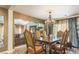 Elegant dining room boasts a chandelier, large table, and an open view of the living room at 11241 Pentland Downs St, Las Vegas, NV 89141