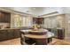 Spacious kitchen with dark wood cabinets, granite countertops, and a unique center island at 11241 Pentland Downs St, Las Vegas, NV 89141