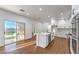 Modern kitchen with an island, stainless steel appliances, and seamless flow to the outdoor patio at 1136 Casady Hollow Ave, Henderson, NV 89012