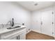 This laundry room features a stainless steel sink and marble countertops at 1136 Casady Hollow Ave, Henderson, NV 89012
