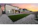 Spacious backyard with artificial turf, a covered patio, and modern landscaping at 12457 Sunset Sage Ave, Las Vegas, NV 89138