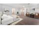 A cozy bedroom features a queen bed, chairs with decorative pillows, and neutral artwork, creating a relaxing atmosphere at 12457 Sunset Sage Ave, Las Vegas, NV 89138