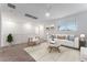 Upstairs living area with carpeted floors, cozy seating, and abundant natural light at 12457 Sunset Sage Ave, Las Vegas, NV 89138