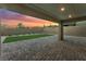 Spacious covered patio with a pavers, privacy walls, and synthetic grass area at 12457 Sunset Sage Ave, Las Vegas, NV 89138