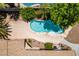 An aerial view shows a pool and landscaped backyard, and patio area, with mature trees enhancing the outdoor living space at 1453 Doggett Ave, Las Vegas, NV 89123