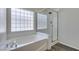 This bathroom features a soaking tub and a glass enclosed shower at 1453 Doggett Ave, Las Vegas, NV 89123