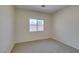 This bedroom features neutral carpeting and a window providing natural light at 1453 Doggett Ave, Las Vegas, NV 89123